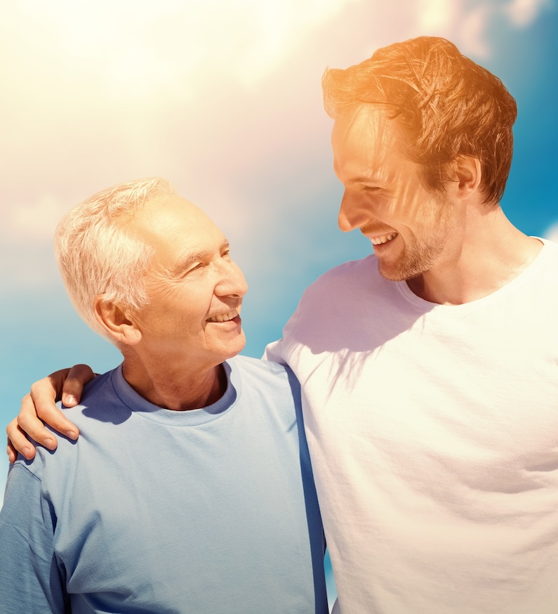 adult son hugging his old father